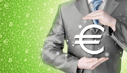 businessman protecting euro symbol