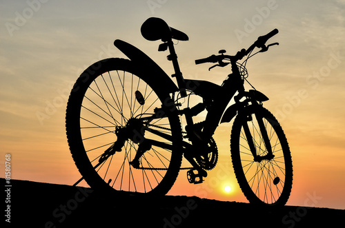 Fototapeta dla dzieci Silhouette of mountain bike with sunset sky 