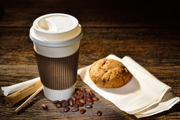 Wall Mural - Paper cup of coffee and cookie on wooden background