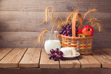 Wall Mural - Jewish holiday Shavuot celebration. Basket with fruits and milk