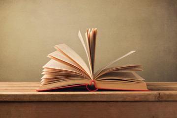 Wall Mural - Open old book on wooden table