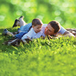 © guas - Summer photo happy father and son together lying on fresh grass