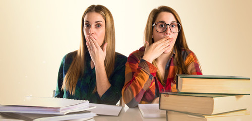 Surprised friends studying together