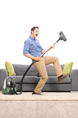 Canvas Print - Guy playing guitar on a vacuum cleaner wand