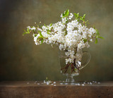 Still life with bouquet of cherry blossoms in a glass jug
