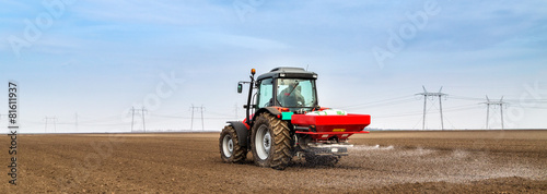 Cuadros en Lienzo Farmer fertilizing arable land with npk fertilizer