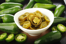 Pickled Sliced Green Jalapeno Peppers In White Bowl