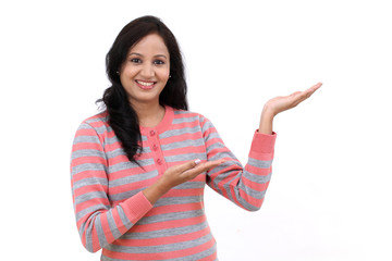 Wall Mural - Young Indian woman showing blank copy space