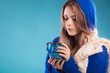 © Voyagerix - teen girl holding blue mug with hot drink