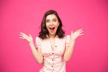 Wall Mural - Surprised woman shouting over pink background