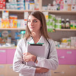 © DC Studio - Pharmacist girl with digital tablet in hand in pharmacy