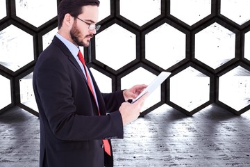 Wall Mural - Composite image of businessman scrolling on his digital tablet