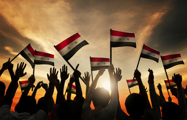 Canvas Print - Group of People Waving Flag of Syria in Back Lit Concept