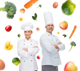 Poster - happy chef couple or cooks over food background