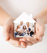 © Syda Productions - close up of hands holding house shape with family