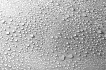 Poster - Water drops on glass on light background