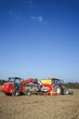 © Countrypixel - Landwirt mit Hoftrak befüllt Sämaschine mit Saatgut