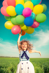 Wall Mural - Child with toy balloons in spring field