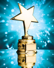 Wall Mural - gold star trophy against blue sparks background