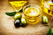 Olives and olive oil. Bowl of extra virgin olive oil
