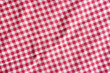 Red and white picnic tablecloth texture.