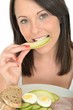 Attractive Healthy Young Woman Eating a Slice of Fresh Melon
