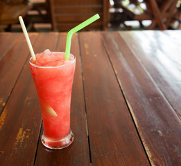 Sticker - Glass of watermelon smoothie on a wooden table. Selective focus