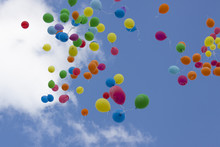 Colorful Balloons Filled With Helium Fly In The Blue Sky