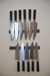 Set of knifes are hanging on kitchen wall