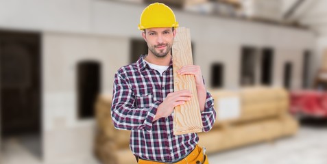 Poster - Composite image of handyman holding wood planks