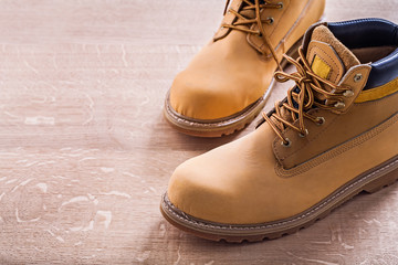 Wall Mural - horizontal view very close up two working shoes On Wooden Board