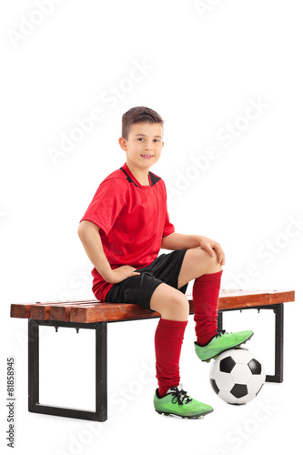 Junior Football Player Sitting On A Bench Buy This Stock Photo