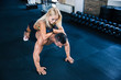 © Drobot Dean - Muscular man doing push ups with woman on back