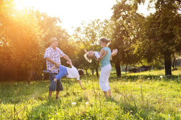 Happy young family spending time together outside in nature