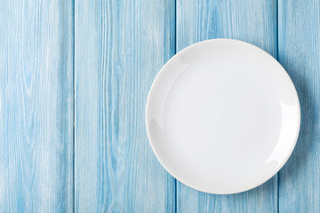 empty plate on blue wooden background