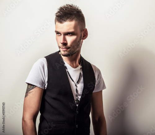 Fototapeta na wymiar Studio portrait of young handsome man in casual white t-shirt 