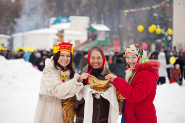 Wall Mural - Women  tasting pancake  during  Shrovetide