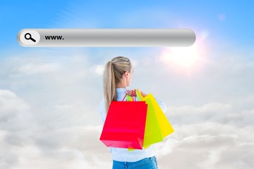 Wall Mural - Composite image of pretty blonde holding shopping bags