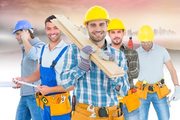 Poster - Composite image of construction worker carrying wooden planks