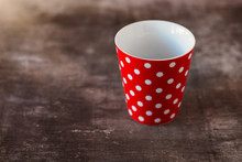 Empty Red Polka Dot Cup On A Wooden Table Background