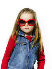 Cute little girl posing in mother's sunglasses, childhood concep