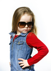 Cute little girl posing in mother's sunglasses, childhood concep