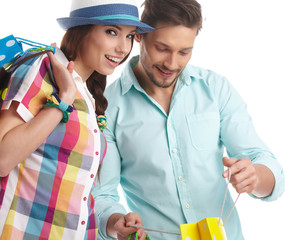 Canvas Print - Young, smiling couple on a shopping spree. Shallow DOF, focus on