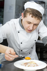 Wall Mural - chef preparing food in the kitchen at the restaurant