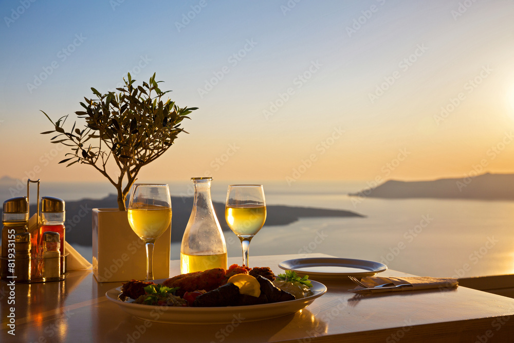 Romantic table for two on the island Santorin - obrazy, fototapety, plakaty 