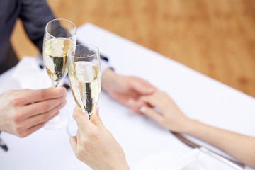 Wall Mural - couple with glasses of champagne at restaurant