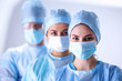 © lenets_tan - Surgeons team, wearing protective uniforms,caps and masks