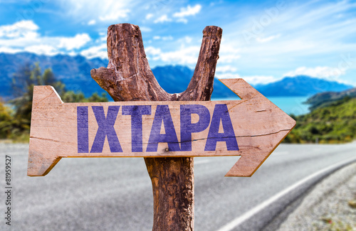 Fotografija Ixtapa wooden sign with road background