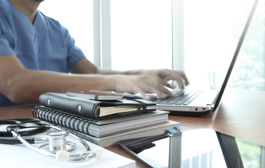 Doctor working with laptop computer in medical workspace office