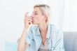 © WavebreakmediaMicro - Pretty blonde woman using her inhaler